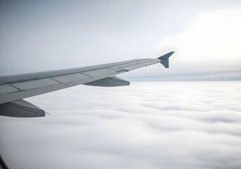 Fototapeta premium Airplane Wing Above a Sea of Clouds Inspiring Travel and Adventure with a Sense of Freedom and Awe from a Window Seat Perspective During Flight
