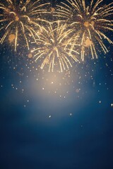 Blue and gold Abstract background and bokeh on New Year's Eve. Vertical Celebratory fireworks illuminating a dark blue sky.