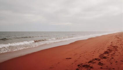 Obraz premium Expansive Sandy Beach with Gentle Waves Under a Cloudy Sky.