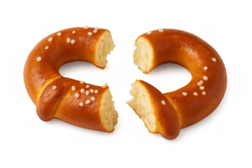 Salty pretzel broken into two pieces, showing the soft interior. Traditional german baked food with a transparent background