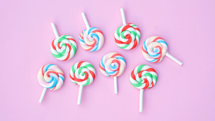 Colorful lollipop on a pink background.