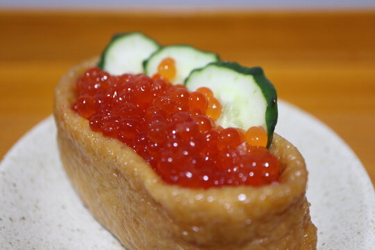 Ikura (salmon roe) inarizushi purchased at a supermarket in Tokyo, Japan - Powered by Adobe
