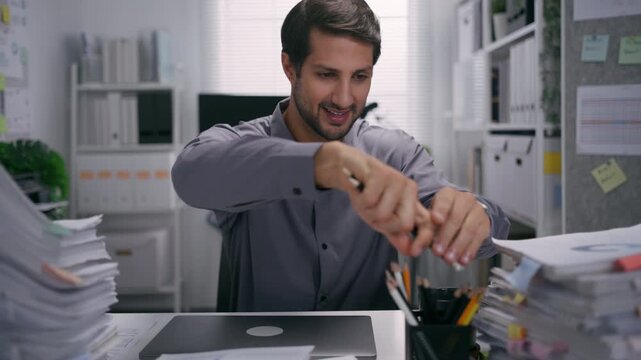 A smiling businessman takes a healthy rest break after he finishes working in the office.