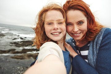Happy mom, portrait and child with selfie on beach for picture, photography or outdoor memory. Mother, daughter or kid with smile for capture moment, bonding or family time by ocean coast or sea