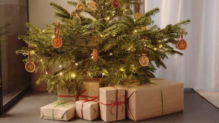 christmas gifts under spruce indoor with warm light