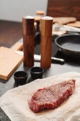 closeup raw seasoned new york steak on concrete countertop background
