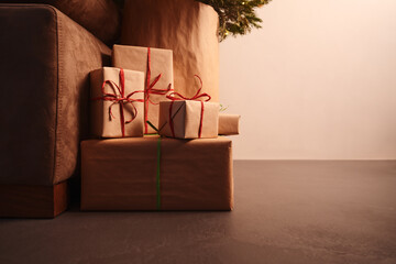 gift boxes under christmas tree with warm light