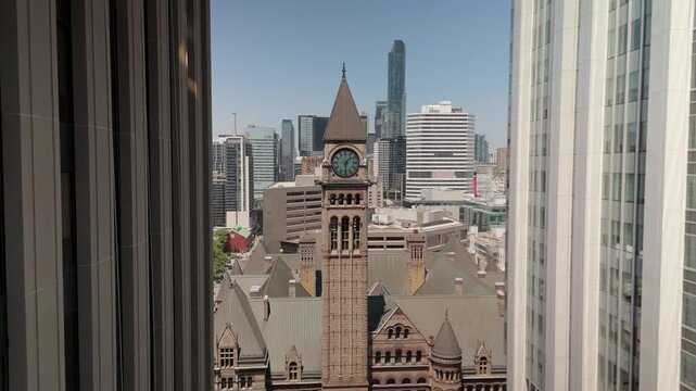 Old City Hall clock tower rising above Toronto skyline