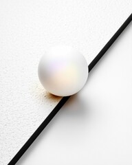 White Sphere Resting on Black Line and Textured Surface