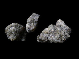 Four Raw Gray Mineral Stones on Black Background