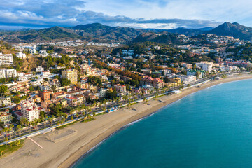 Vibrant Coastal Metropolis: Sweeping Aerial View of M&aacute;laga, Spain, Featuring Palm Tree-Lined Beaches, the Bustling Port, and the Expanding Cityscape