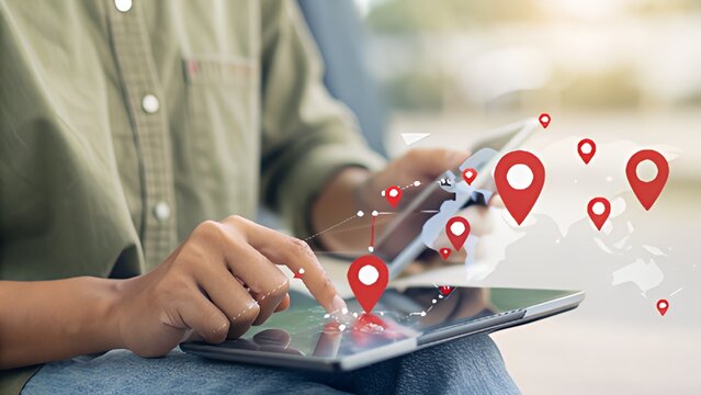 Person using tablet with location pins, visualizing global network connectivity concept - Powered by Adobe