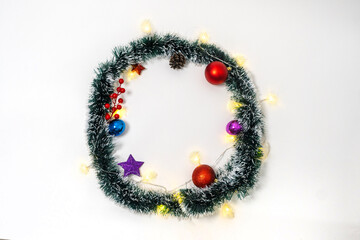 christmas border with lights garland, christmas branches, stars, pine cones, berries on white background, christmas and holiday celebration,banner or template background.