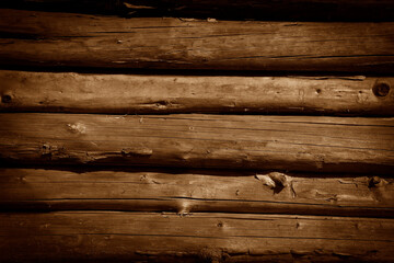 Wall of brown wooden planks in the background of a rural house.