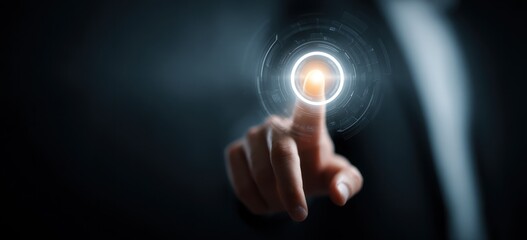 Finger touching glowing digital interface button in dark setting