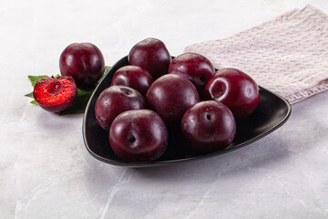 Raw ripe purple plum heap