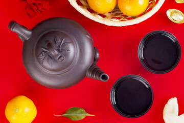 Traditional Chinese Tea Ceremony Flat Lay with Teapot, Tea Cups, and Mandarin Oranges for T?t