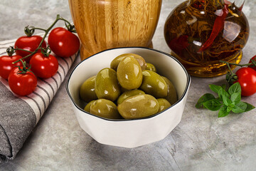 Big green marinated olives in the bowl