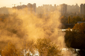 Scenic urban landscape view of foggy lake in Kyiv at sunset