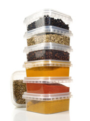 Various Spice in Plastic Boxes on white Background