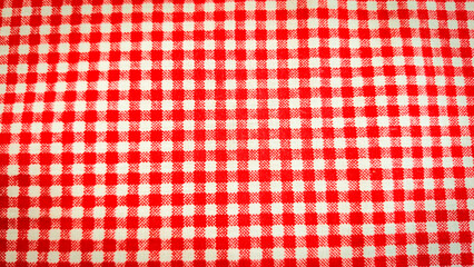 A seamless red and white gingham checkered pattern featuring alternating squares in a classic grid layout