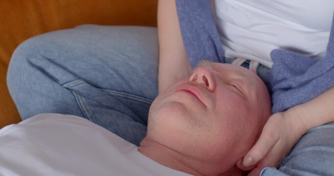 A soothing head massage session promoting relaxation and stress relief. A practitioner provides gentle support and comfort while focusing on the head area.
