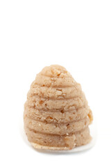 Traditional Silesian bee-hive shaped cookies made from ground nuts on a clean white background, regional Polish dessert prepared for holidays and local culinary culture