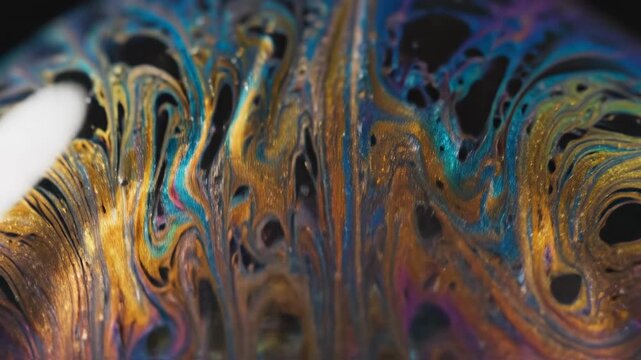 Macro shot of expanding and shrinking bubble surface details displaying extremely vibrant shifting iridescent colors in smooth slow motion shimmeringlight, shiftingiridescentcolors, soapbubble