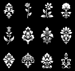 Collection of twelve white floral and damask ornamental motifs on black