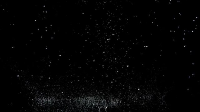 Super Slow Motion Shot of Real Raindrops Falling on a Surface, Isolated on Black, at 1000fps