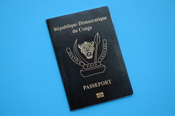 Democratic Republic of Congo black passport on light blue table background close up. Concept of...