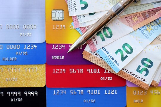 Credit cards and pen with euro currency money bills banknotes. Business, financial operations and accounting in European Union - Powered by Adobe