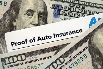 Proof of auto insurance card and many hundred dollar bills. Concept of insurance policy and car accident