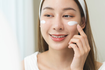 Routine skin care concept, Close-up woman applying cream on her face