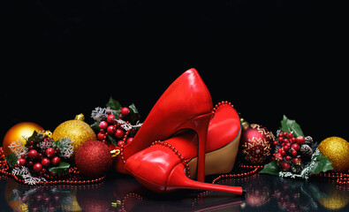 Women's stiletto heels near Christmas decorations on table