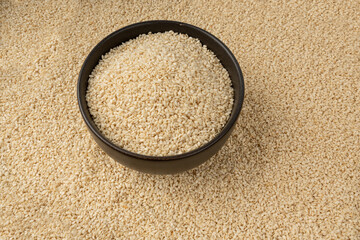 Sesame seeds pile closeup, white small benne grains. Sesamum indicum fruits