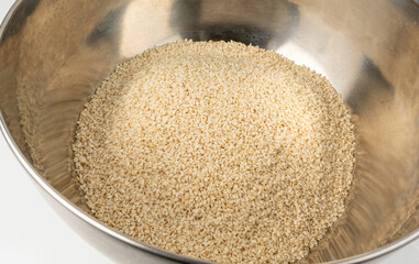 Sesame seeds pile closeup, white small benne grains. Sesamum indicum fruits