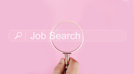A hand holding a magnifying glass over a digital search bar that reads Job Search represents online job searching, career exploration, recruitment trends, and modern job search Technology technology