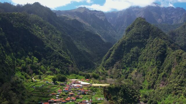 Explore the stunning aerial view of Madeira's majestic mountains, lush landscapes, and charming villages. Discover the beauty of rural living in this picturesque region of Portugal.