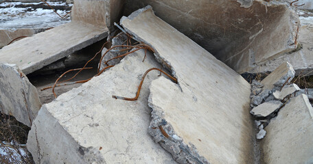 Pieces of broken concrete and a metal in a landfill