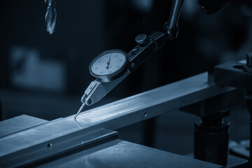 Close up scene the work alignment setup by dial indicator in the blue tone scene.
