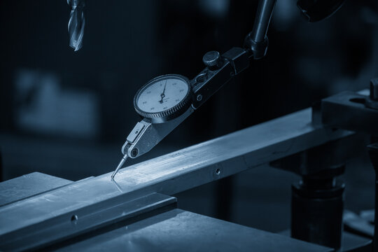 Close up scene the work alignment setup by dial indicator in the blue tone scene.