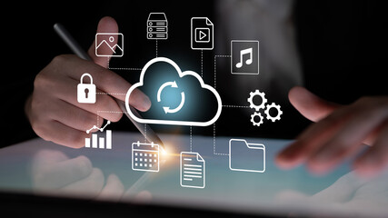 A businessman interacts with a tablet displaying cloud storage icons, highlighting data sync, security, and management for modern technology and business solutions. Gantry