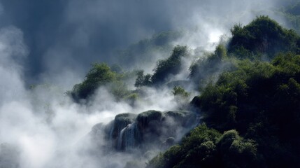 A misty mountain landscape with lush green vegetation and a waterfall cascading down the side of the mountain, surrounded by dense foliage and a cloudy sky.