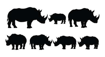 Silhouette of a rhino family walking across a plain nature s majestic creatures