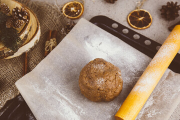 Raw dough for Christmas cookies on wooden board