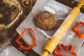 Raw dough for Christmas cookies on wooden board
