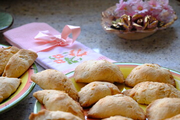 Fresh apple cookies, fresh from the oven. A Turkish-embroidered napkin with a pink ribbon. A pink floral decorative plate. Homemade cookies. Turkish cuisine. Tea time. Ramadan iftar. A green cup.