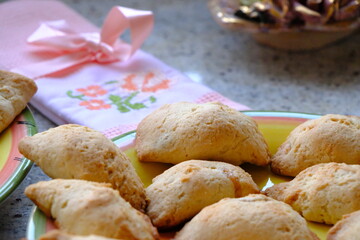 Fresh apple cookies, fresh from the oven. A Turkish-embroidered napkin with a pink ribbon. A pink floral decorative plate. Homemade cookies. Turkish cuisine. Tea time. Ramadan iftar. A green cup.