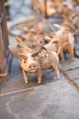 Reindeer in the snow.Close-up of a whimsical, handcrafted wooden pig figurine with straw accents. Traditional Christmas or lucky charm souvenir at the German market